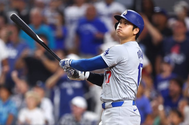 MIAMI, FLORIDA - SEPTEMBER 19: Shohei Ohtani #17 of the Los Angeles Dodgers hits a two-run home run, his 50th of the season, becoming the first player with a 50/50 season in MLB history, during the seventh inning against the Miami Marlins at loanDepot park on September 19, 2024 in Miami, Florida. (Photo by Megan Briggs/Getty Images)