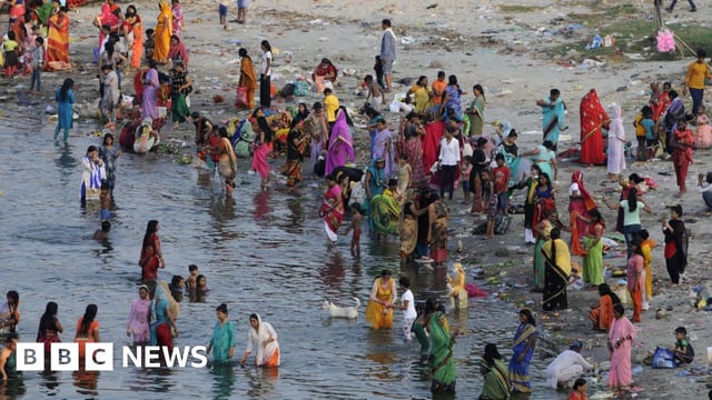 Women and children bathe in a river during Jivitputrika festival in the Uttar Pradesh state, northern India. Photo: September 2020