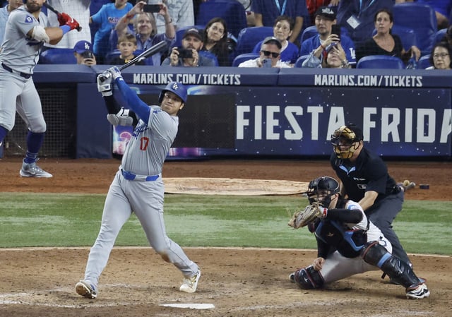 Sep 19, 2024; Miami, Florida, USA; Los Angeles Dodgers designated hitter Shohei Ohtani (17) hits his 50th home run of the season against the Miami Marlins during the seventh inning at loanDepot Park. Mandatory Credit: Rhona Wise-Imagn Images/File Photo