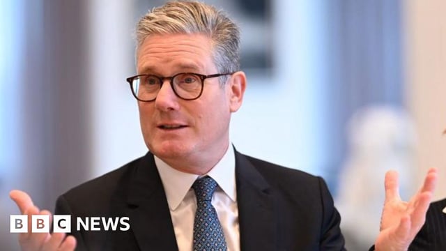 Prime Minister Keir Starmer sat at a breakfast meeting in New York looking animated and wearing a suit