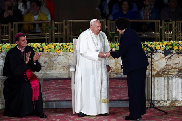 Pope Francis shakes hands with Mia De Schamphelaere, coordinator of point of contact for victims of abuse, at the Koekelberg Basilica in Brussels, Belgium, September 28, 2024. REUTERS/Guglielmo Mangiapane