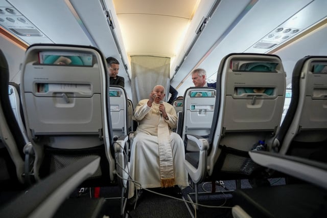 Pope Francis talks to journalists on the flight back to Rome at the end of his four-day visit to Belgium and Luxembourg, September 29, 2024. Andrew Medichini/Pool via REUTERS/File Photo