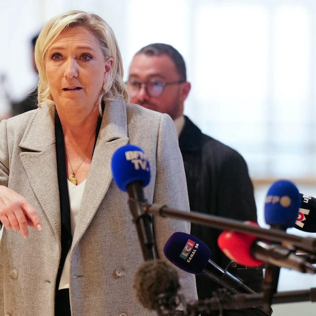 French far-right Rassemblement National (RN) Member of Parliament Marine Le Pen addresses the press as she arrives at a court house for a trial on suspicion of embezzlement of European public funds, in Paris on September 30, 2024. The trial of Marine Le Pen, 24 other people and the National Rally, suspected of having embezzled funds from the European Parliament to pay party employees, opens on September 30, 2024, before the Paris criminal court, a case with serious political stakes for the leader of the far right. (Photo by Dimitar DILKOFF / AFP) (Photo by DIMITAR DILKOFF/AFP via Getty Images)