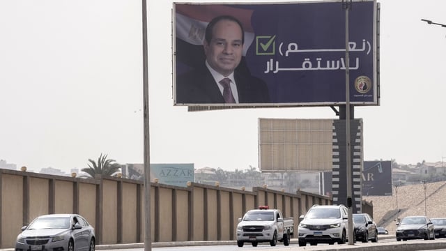 Vehicles pass under a billboard supporting Egyptian President Abdel Fattah el-Sissi for the coming presidential elections, erected by Egypt's political party of Homat Watan, the Protectors of the Nation, in Cairo, Egypt, Monday, Sept. 4, 2023. Arabic reads, "yes for stability." (AP Photo/Amr Nabil)