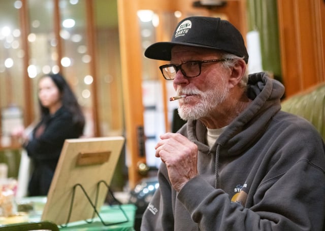 FILE: Phil Crew, owner of Mendocino Family Farms, smokes a joint of his own cannabis during a farmers market at a cannabis consumption lounge.