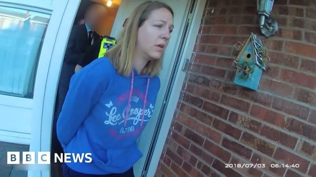 Lucy Letby, wearing a blue Lee Cooper branded hoodie, is led away from her front door in handcuffs