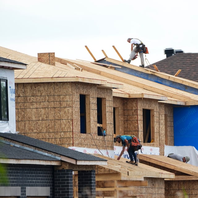 A report by Canada Mortgage and Housing Corp. says higher interest rates decreased housing starts by about 30,000 units in 2023.New homes are built in Ottawa on Monday, Aug. 14, 2023.THE CANADIAN PRESS/Sean Kilpatrick