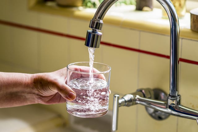 Pouring a glass of water from a kitchen faucet in Santa Ana on April 26, 2024.
