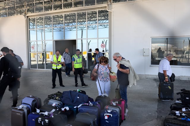 Australian nationals evacuated from Lebanon, due to ongoing hostilities between Hezbollah and the Israeli forces, arrive at Larnaca International Airport, in Larnaca, Cyprus, October 5, 2024. REUTERS/Yiannis Kourtoglou