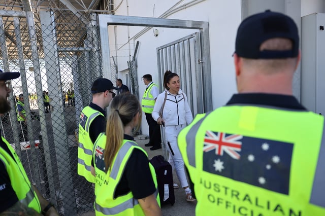 Australian officials stand by as Australian nationals, evacuated from Lebanon due to ongoing hostilities between Hezbollah and the Israeli forces, arrive at Larnaca International Airport, in Larnaca, Cyprus, October 5, 2024. REUTERS/Yiannis Kourtoglou