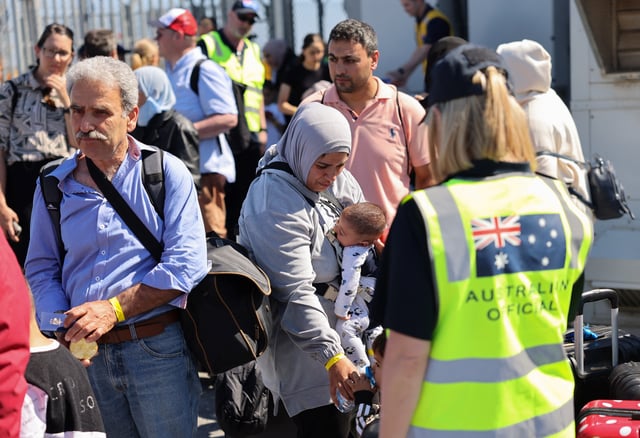 Australian officials stand by as Australian nationals, evacuated from Lebanon due to ongoing hostilities between Hezbollah and the Israeli forces, arrive at Larnaca International Airport, in Larnaca, Cyprus, October 5, 2024. REUTERS/Yiannis Kourtoglou