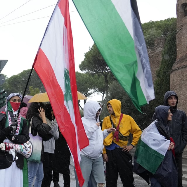 People stand during a protest in Rome, Saturday, Oct. 5, 2024. Pro-palestinians people take to the street in an unauthorised march in the centre of Rome two days ahead of the first anniversary of the Oct. 7. (AP Photo/Andrew Medichini)