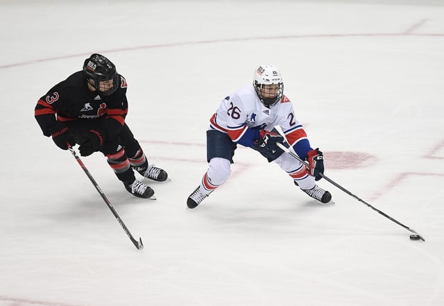 Kendall Coyne Schofield #26 of Team United States skates with the puck as Jocelyne Larocque #3 of Team Canada defends in overtime during the Rivalry Rematch at PPG PAINTS Arena on March 12, 2022 in Pittsburgh, Pennsylvania.