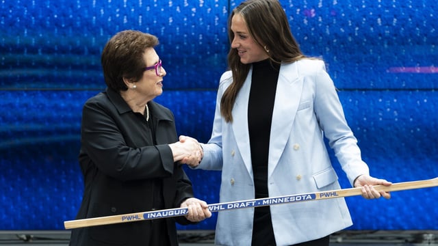 CORRECTS TO TAYLOR HEISE NOT TAYLER HEISE - Taylor Heise, right, shakes hands with tennis legend Billie Jean King after being selected first overall by Minnesota in the inaugural Professional Women's Hockey League draft in Toronto, Monday, Sept. 18, 2023. (Spencer Colby/The Canadian Press via AP)