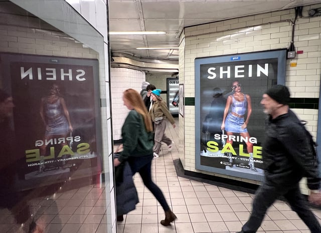 People walk past an advertisement for Shein, March 8, 2024 in London, Britain. REUTERS/Suzanne Plunkett/File Photo