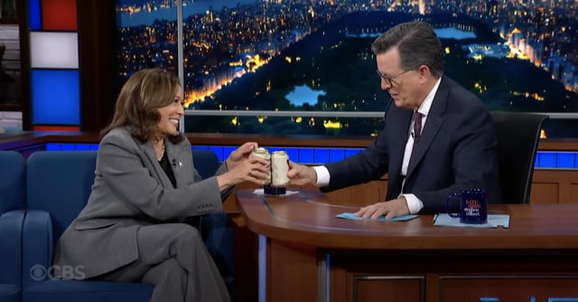 Screengrab of video showing Kamala Harris and Stephen Colbert clinking their beer cans together after cracking into some Miller High Lifes on 'The Late Show.'