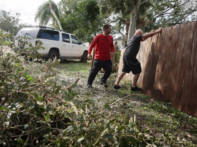 Men work on cleaning-up after the arrival of Hurricane Milton on October 10, 2024 in Gulfport, Florida. Milton, which comes just after the recent catastrophic Hurricane Helene, landed into Florida's Gulf Coast late Wednesday evening as a Category 3 storm causing extensive flooding and damage. (Photo by Spencer Platt/Getty Images)