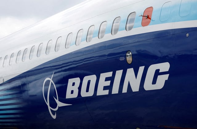 The Boeing logo is seen on the side of a Boeing 737 MAX at the Farnborough International Airshow, in Farnborough, Britain, July 20, 2022.  REUTERS/Peter Cziborra/File Photo