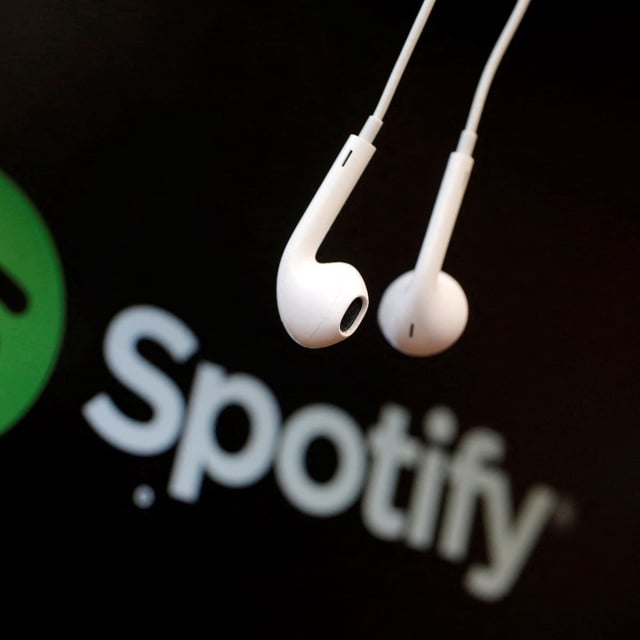 FILE PHOTO: Headphones are seen in front of a logo of online music streaming service Spotify in this illustration picture taken in Strasbourg, February 18, 2014. REUTERS/Christian Hartmann/File Photo