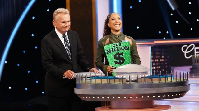 Pat Sajak and Robin Thede in "Celebrity Wheel of Fortune." (Disney/Christopher Willard)