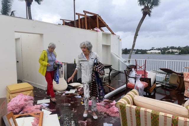Bayou West resident Mary Singer, 82, and friend Brita Gwynn, 84, try to salvage items from Singer's second floor home after an apparent tornado touched down on the central beach community, leaving a path of destruction after Hurricane Milton in Vero Beach, Florida, U.S. October 11, 2024.  Kaila Jones/USA Today Network via REUTERS. 
NO RESALES. NO ARCHIVES