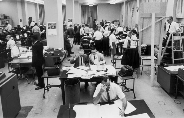 FILE – Staffers work on election night at the Washington bureau of The Associated Press on Nov. 3, 1964. (AP Photo, File)