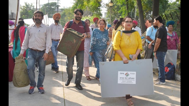 Polling officials carry voting materials before leaving for their respective polling booths on the eve of gram panchayat elections in Amritsar on Monday. (Sameer Sehgal/Hindustan Times)