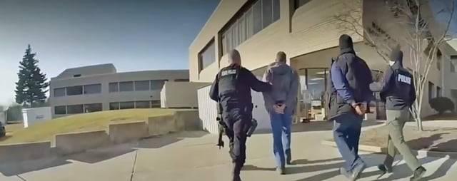 Police escort Brandon Woodruff, second from right, during an unnanounced active shooter drill at the Hawthorn Center in Northville Township, Mich., on Dec. 21, 2022.