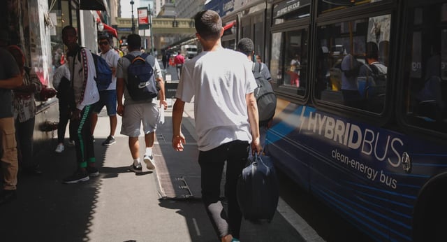 Migrants arrive on a bus outside the Roosevelt Hotel in midtown Manhattan.