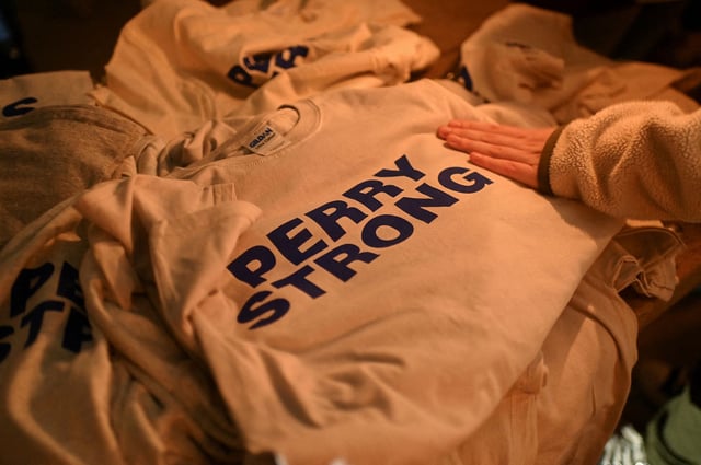 T-shirts reading "Perry Strong" were available at a vigil following a shooting at Perry High School in Perry, Iowa, on January 4, 2024.