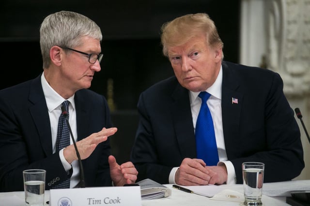 Apple CEO Tim Cook speaking with former President Donald Trump during a meeting at the White House in March 2019.