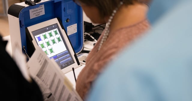 People test the polling equipment at the Hays County election office on Sept. 18, 2024.