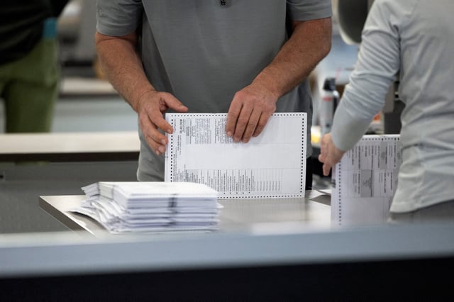 An election worker processes ballots at Philadelphia's vote counting facility on Pennsylvania's primary election day in Philadelphia, Pennsylvania, on April 23, 2024.
