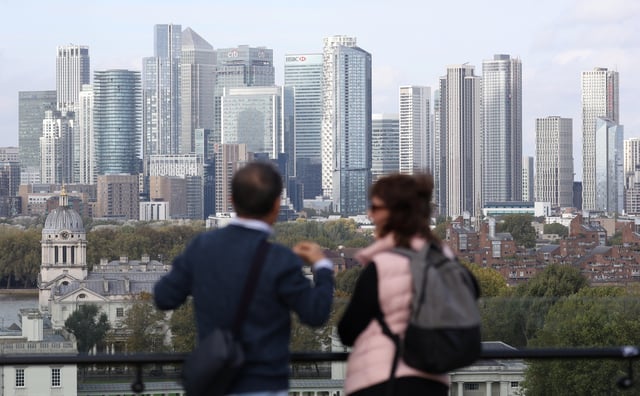 People look out towards the Canary Wharf financial district from Greenwich Park, in London, Britain, October 16, 2024. REUTERS/Mina Kim/File Photo