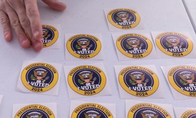A voter picks up an "I Voted" sticker after casting an early ballot in Arlington, Virginia, on September 20, 2024.