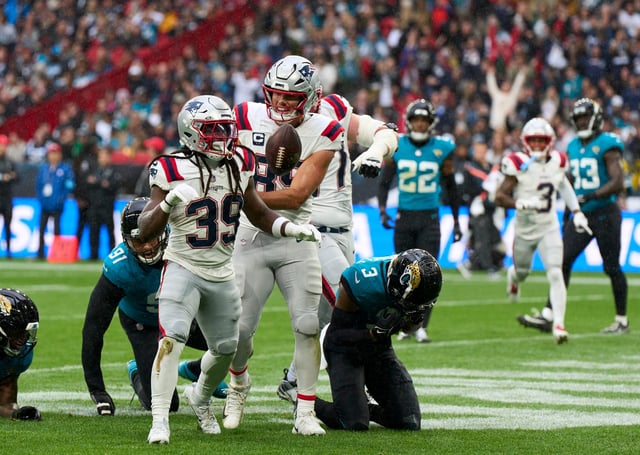Oct 20, 2024; London, United Kingdom; New England Patriots running back JaMycal Hasty (39) reacts after a touchdown with New England Patriots tight end Hunter Henry (85) in the first half during an NFL International Series game at Wembley Stadium. Mandatory Credit: Peter van den Berg-Imagn Images