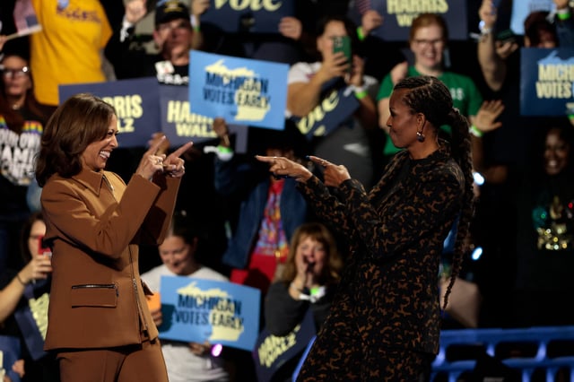 US Vice President and Democratic presidential candidate Kamala Harris is greeted by former first lady Michelle Obama on stage at a campaign rally in Kalamazoo, Michigan, on October 26, 2024. (Photo by JEFF KOWALSKY / AFP) (Photo by JEFF KOWALSKY/AFP via Getty Images)
