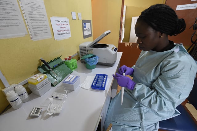 A health official works in the laboratory extraction room of the Institute of Lassa Fever Research and Control in Irrua Specialist Teaching Hospital in Irrua, Edo State, midwest Nigeria, on March 6, 2018. Lassa fever is endemic in West Africa.