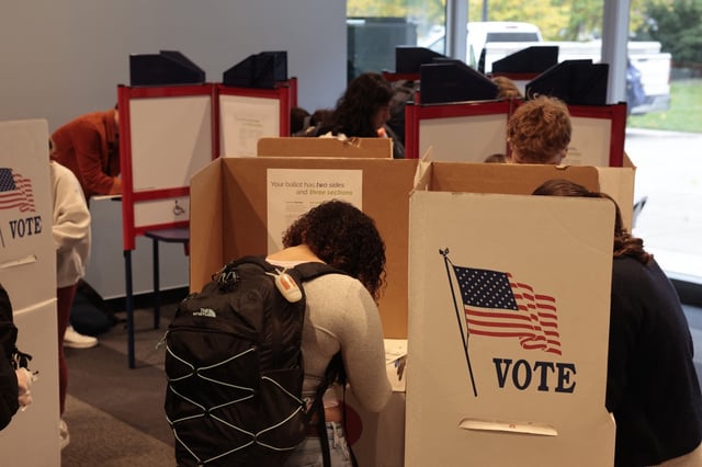 People cast their ballots during early voting at the University of Michigan Museum of Art Gallery in Ann Arbor, Mich. 