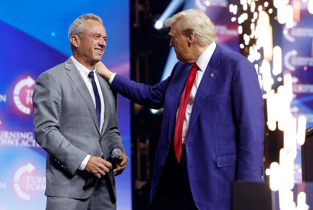 Republican presidential nominee, former U.S. President Donald Trump welcomes Robert F. Kennedy Jr. to the stage at a Turning Point Action campaign rally at the Gas South Arena on October 23, 2024 in Duluth, Georgia. Trump is campaigning across Georgia today as he and Democratic presidential nominee, U.S. Vice President Kamala Harris attempt to win over swing state voters.