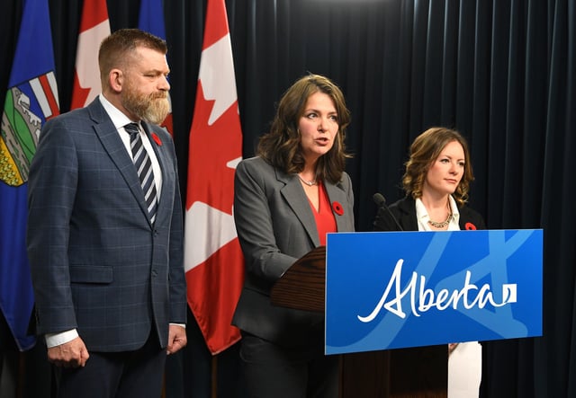 Premier Danielle Smith, flanked by Energy Minister Brian Jean and Environment Minister Rebecca Schulz, at a news conference in Edmonton on Monday, November 4, 2024.