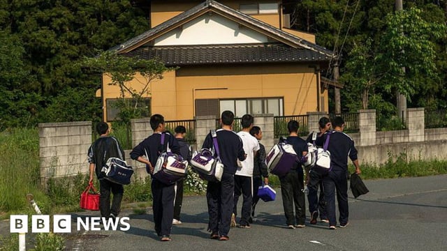 A group of Japanese teenage boys walking on the street