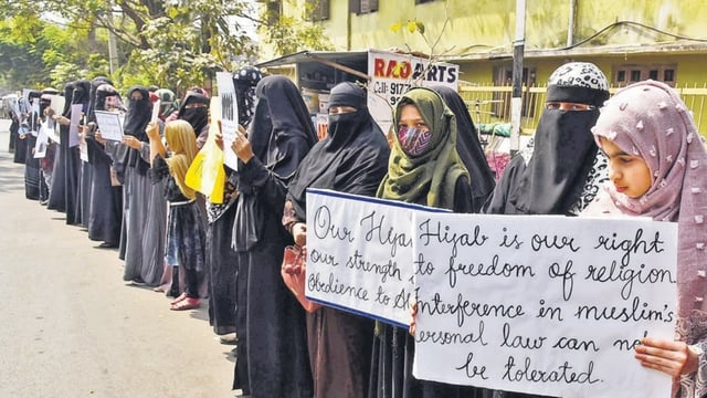 Women and girls holding placards stage a peaceful protest over the hijab ban imposed in the few colleges in Karnataka