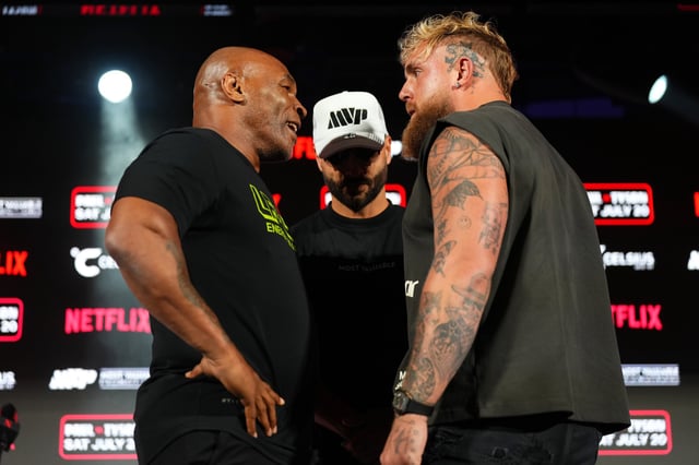 Mike Tyson (left) and Jake Paul (right) pose onstage at Texas Live! on May 16, 2024, during the press conference for their upcoming fight.