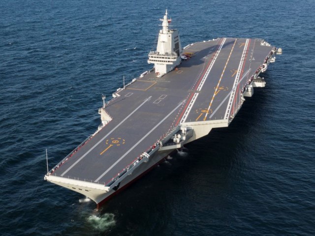 An aerial drone photo taken on May 1, 2024 shows China's third aircraft carrier, the Fujian, during its maiden sea trials. China's third aircraft carrier, the Fujian, returned to Shanghai Jiangnan Shipyard at around 3 p.m. Wednesday after completing its maiden sea trials. (Photo by Pu Haiyang/Xinhua via Getty Images)