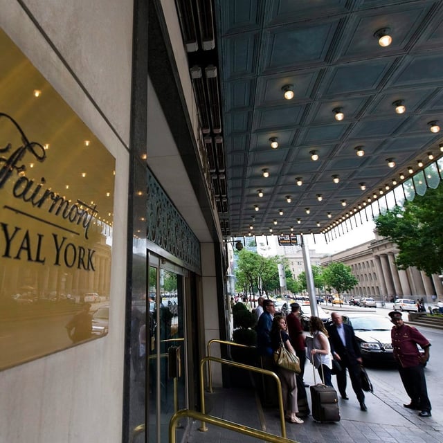 A group of hotel service workers in Toronto are set to hold a rally today outside the Fairmont Royal York to demand a salary increase as hotel costs in the city skyrocket during Taylor Swift’s concerts. Doormen work at the Royal York Hotel in Toronto on Thursday, June 3, 2010. THE CANADIAN PRESS/Adrien Veczan