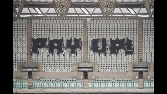 Activists with signs spell out pay up for climate finance in the Baku Olympic Stadium during the COP29 U.N. Climate Summit, Thursday, Nov. 14, 2024, in Baku, Azerbaijan. (AP Photo/Sergei Grits) (AP)