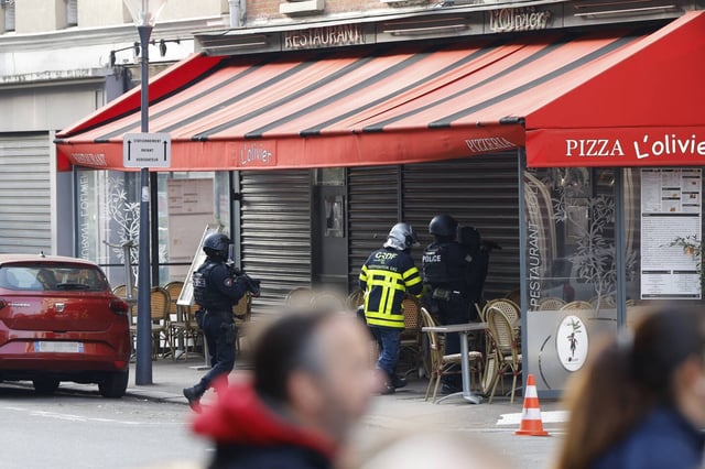 Des policiers devant le restaurant "Pizza L'Olivier" à Issy-les-Moulineaux, en banlieue parisienne, le 16 novembre 2024, où le propriétaire du restaurant est "retranché" dans son établissement et détient "plusieurs salariés".