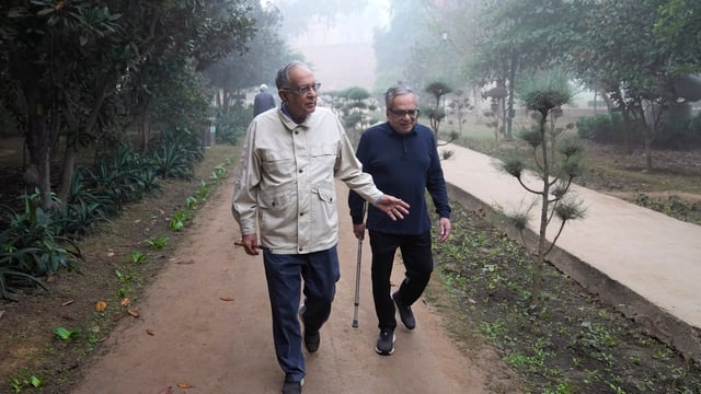 Rajiv Sikri, left, and Subodh Jain take a morning walk in Lodhi Gardens in New Delhi, India, Friday, Nov. 15, 2024. (AP Photo/Manish Swarup)