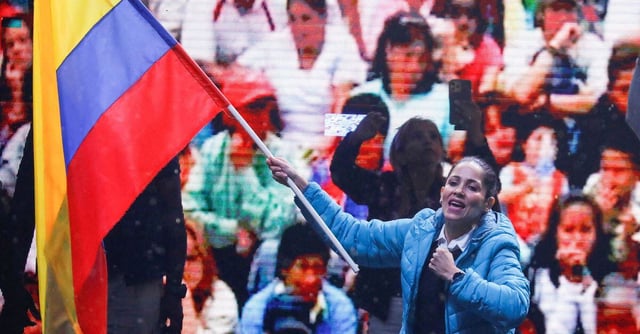 Ecuadorean presidential candidate Luisa Gonzalez waves Ecuador's flag as vice presidential candidate Andres Arauz looks on during a campaign rally, in Quito, Ecuador October 11, 2023. REUTERS/Karen Toro/File Photo